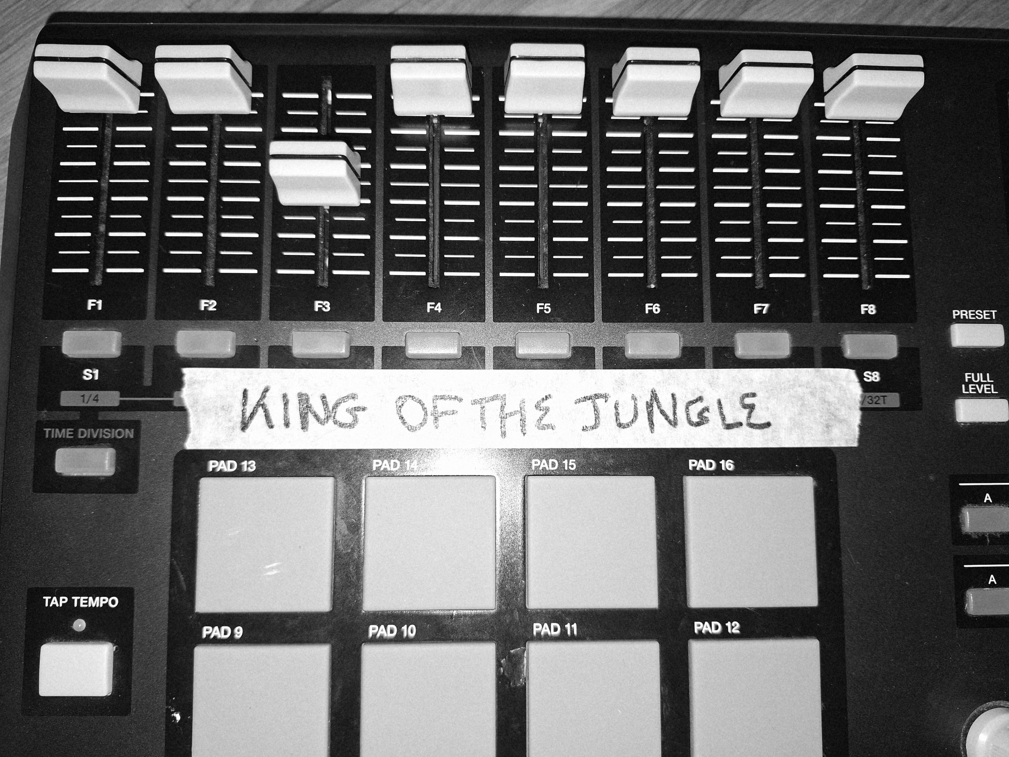 Studio mixer with a 'KING OF THE JUNGLE' tape strip across the console